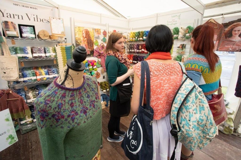 knitters browsing colourful booth of yarn at woollinn yarn festival