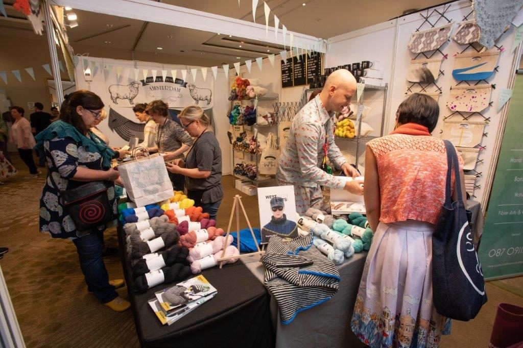 knitters shopping for yarn at vendor booth at woollinn yarn festival